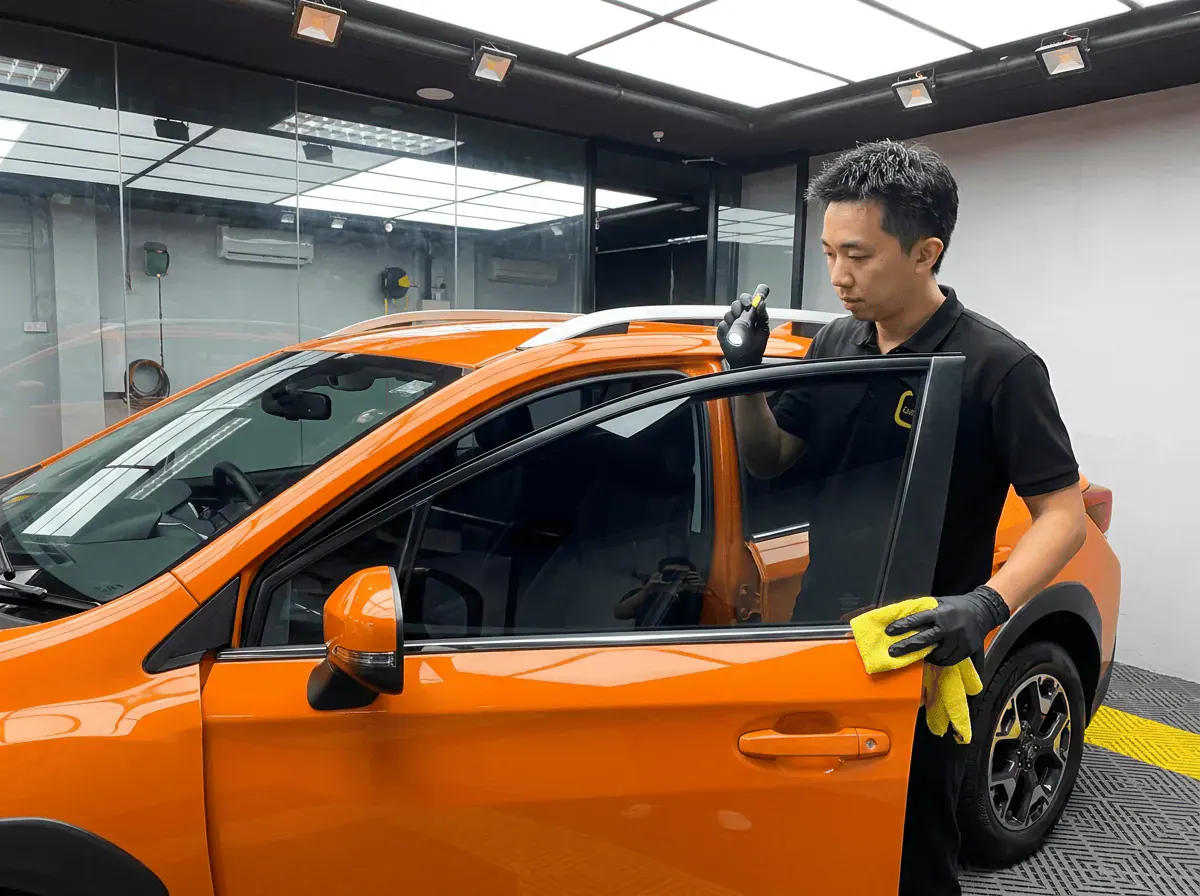 Pemeriksaan kualiti dengan lampu suluh semasa pemasangan tinted pada Subaru Crosstrek