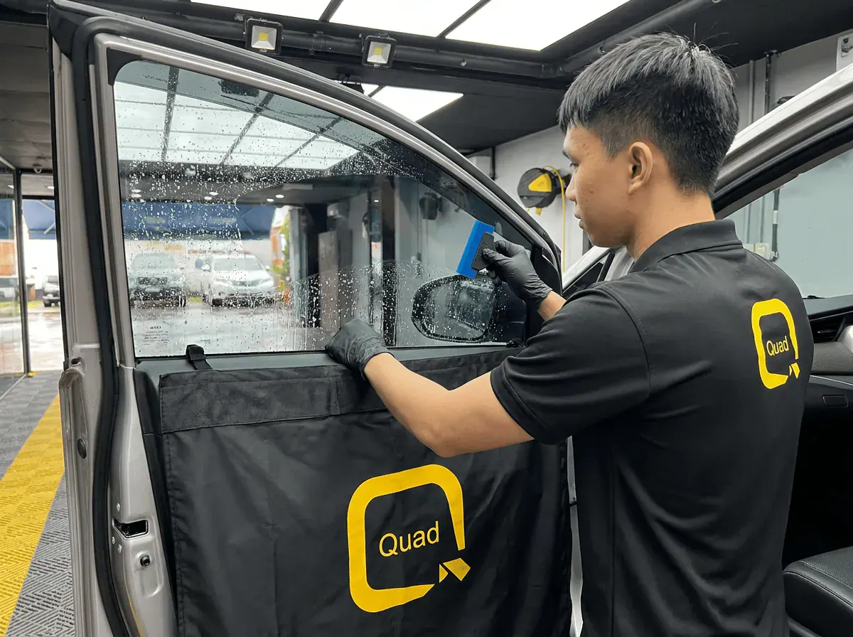Pemasangan filem dan penyingkiran air semasa pemasangan tinted pada Toyota Innova