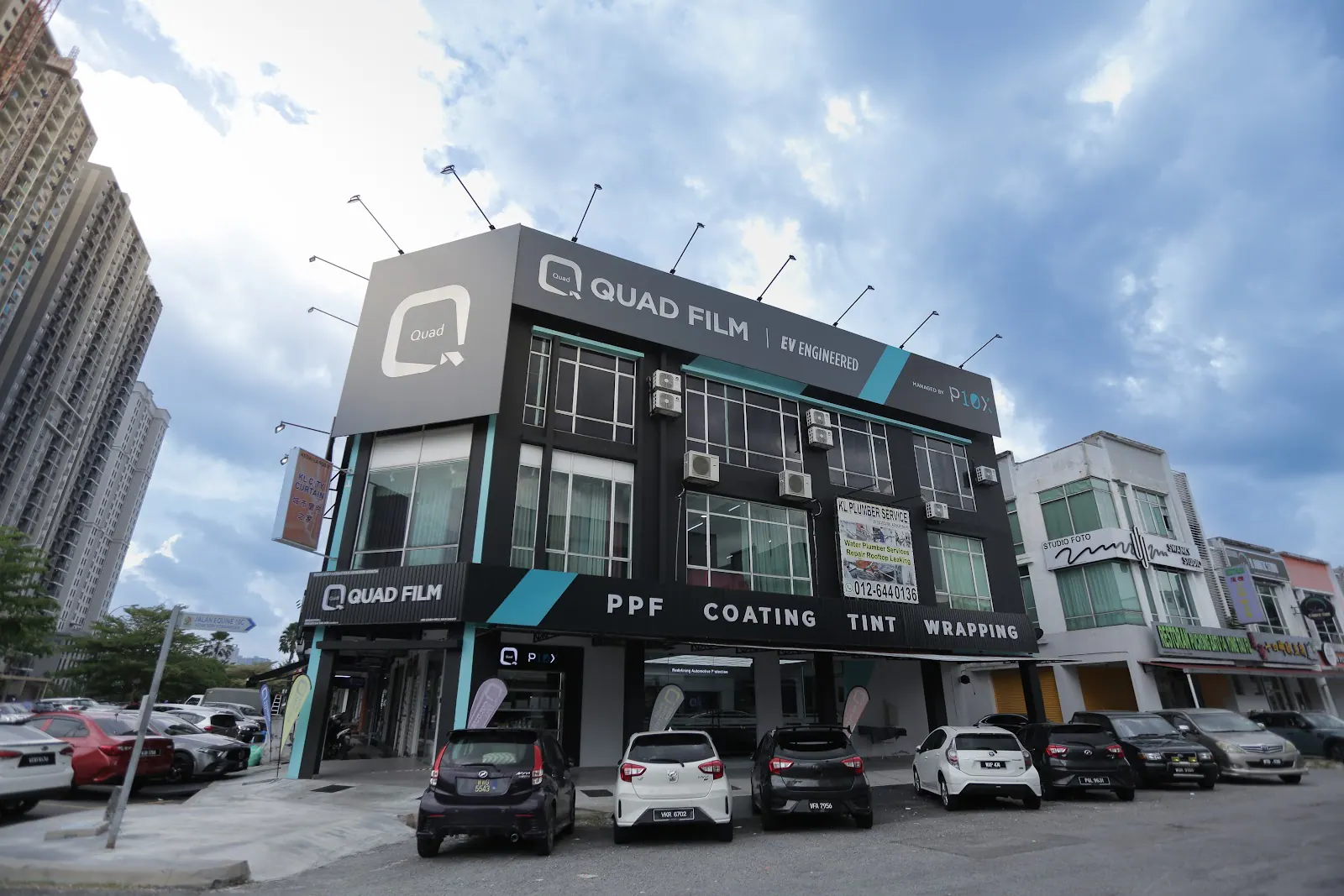 BMW iX3 PPF Malaysia owners can inspect a Quad Film outlet in person, shown here from the street with the service bay visible