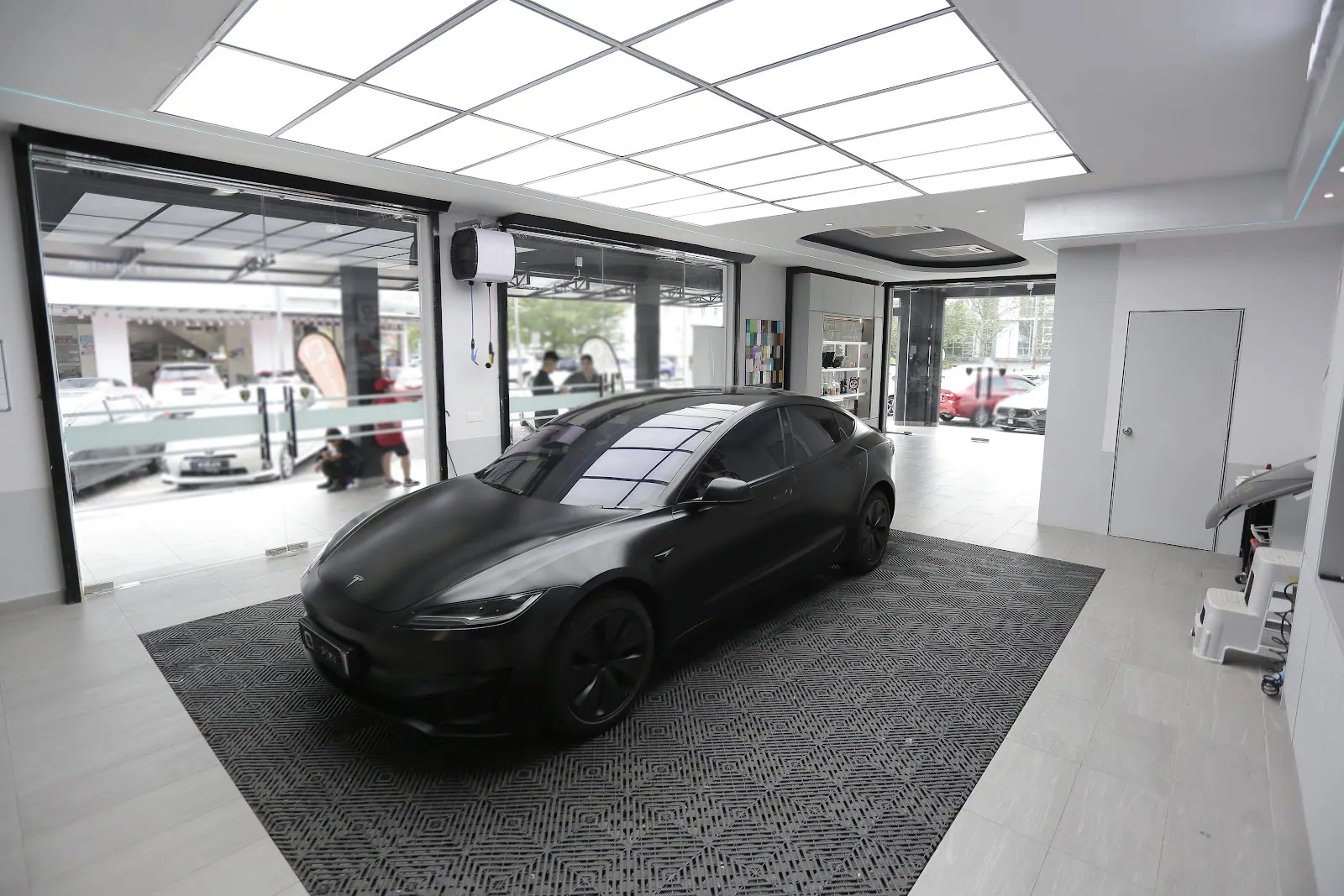 A showroom display bay, the kind of space where a Proton X50 PPF coverage list gets worked out before any film is cut.