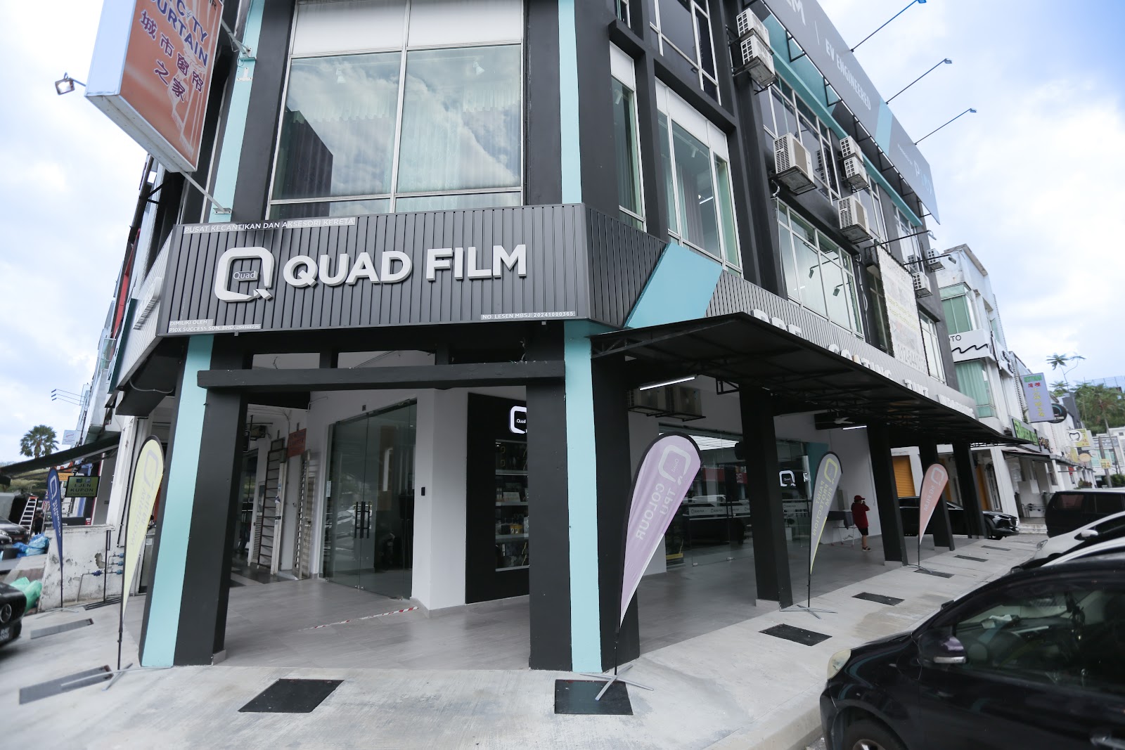 quad film outlet corner storefront